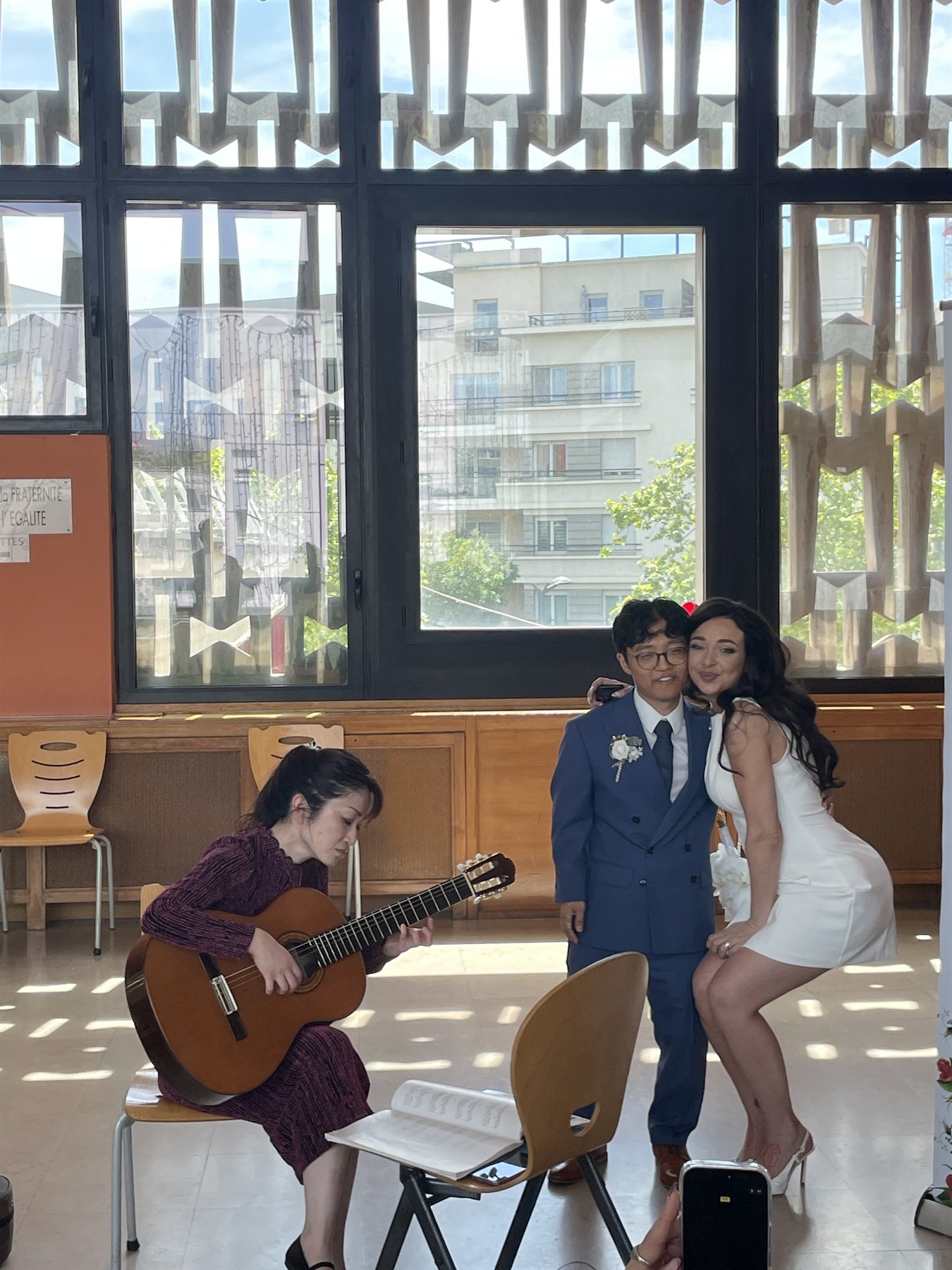 Elea and Isaac with a musician during the celebration